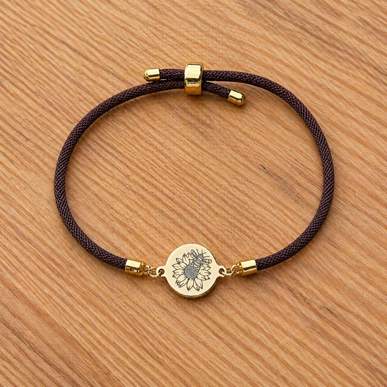 Bumble bee on sunflower on 21mm round golden on textile cord brown
