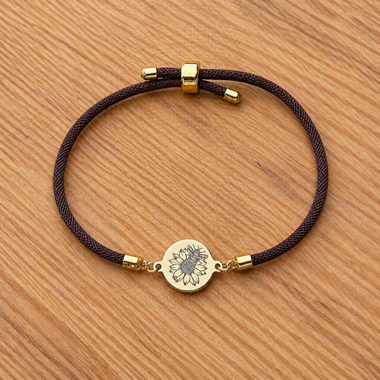 Bumble bee on sunflower on 21mm round golden on textile cord brown