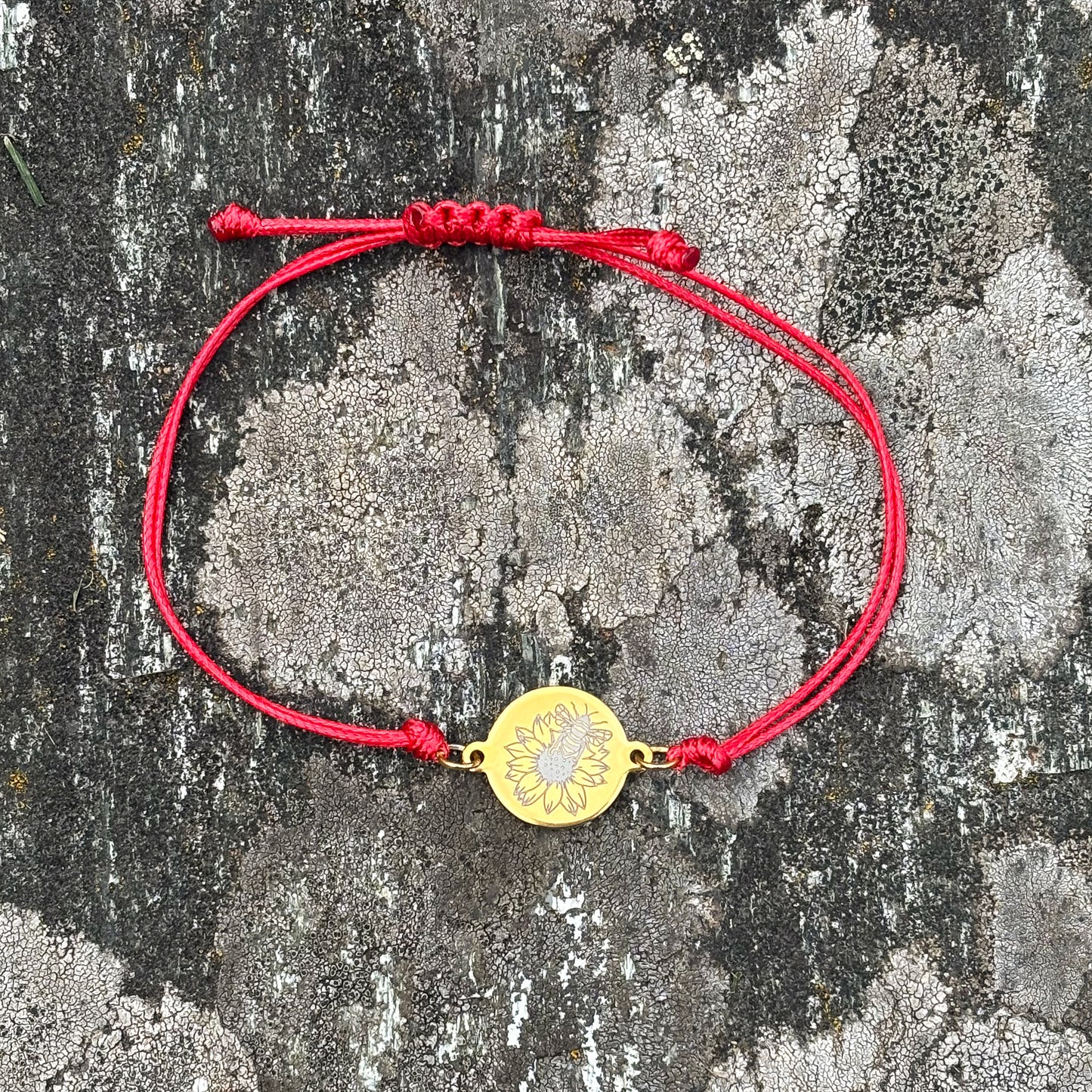 Bumble bee on sunflower on 21mm round golden on thin cord red