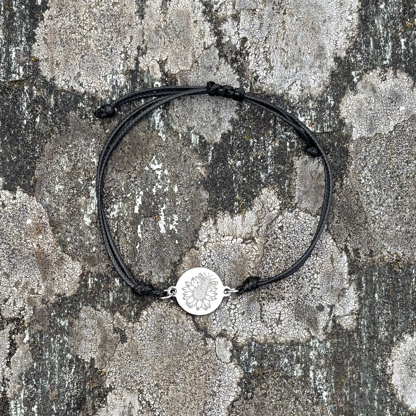 Bumble bee on sunflower on 21mm round silver on thin cord black
